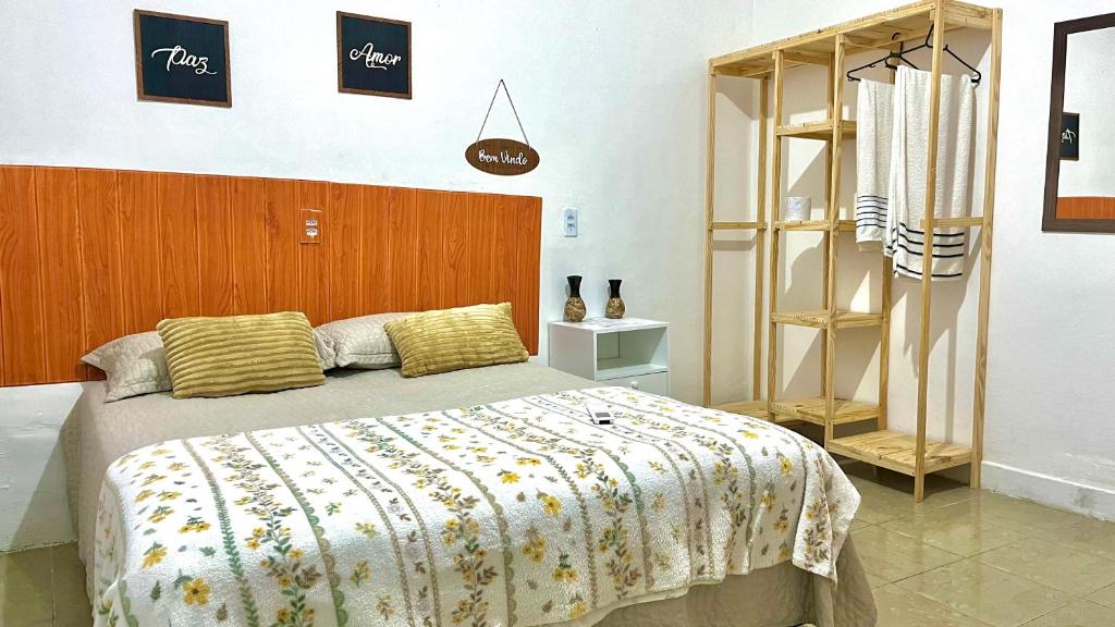 um quarto com uma cama grande e uma cabeceira em madeira em Pousada Mar & Sol em Fortaleza