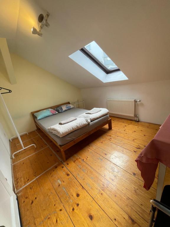 a bedroom with a bed with a skylight at U6 Schöpfwerk Home 7 in Vienna
