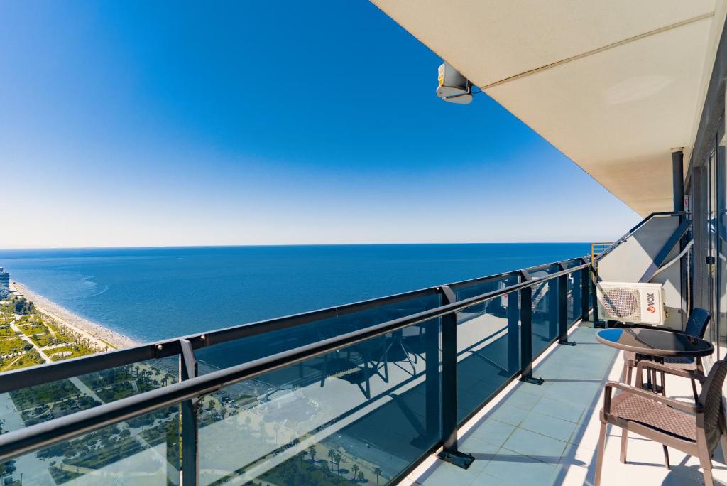 a balcony with a view of the ocean at Apartments Beach Tower in Batumi