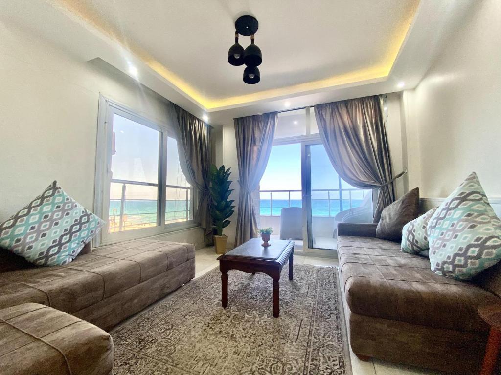 a living room with a couch and a table at Alexandria Luxury Apartments Sporting Direct Sea View in Alexandria