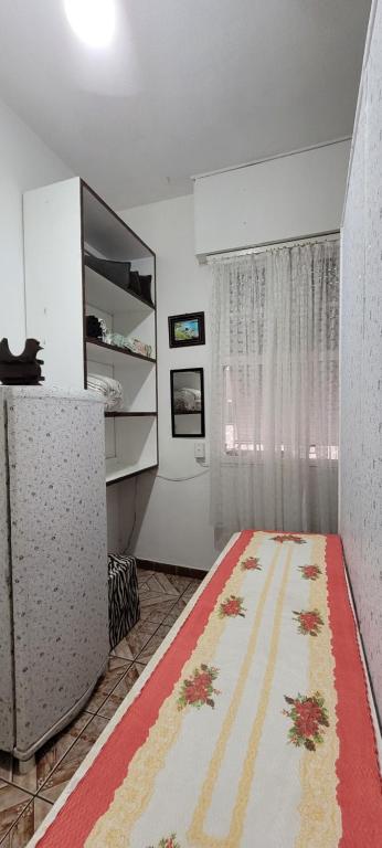 a living room with a rug on the floor at Apto no Embaré pé na areia in Santos