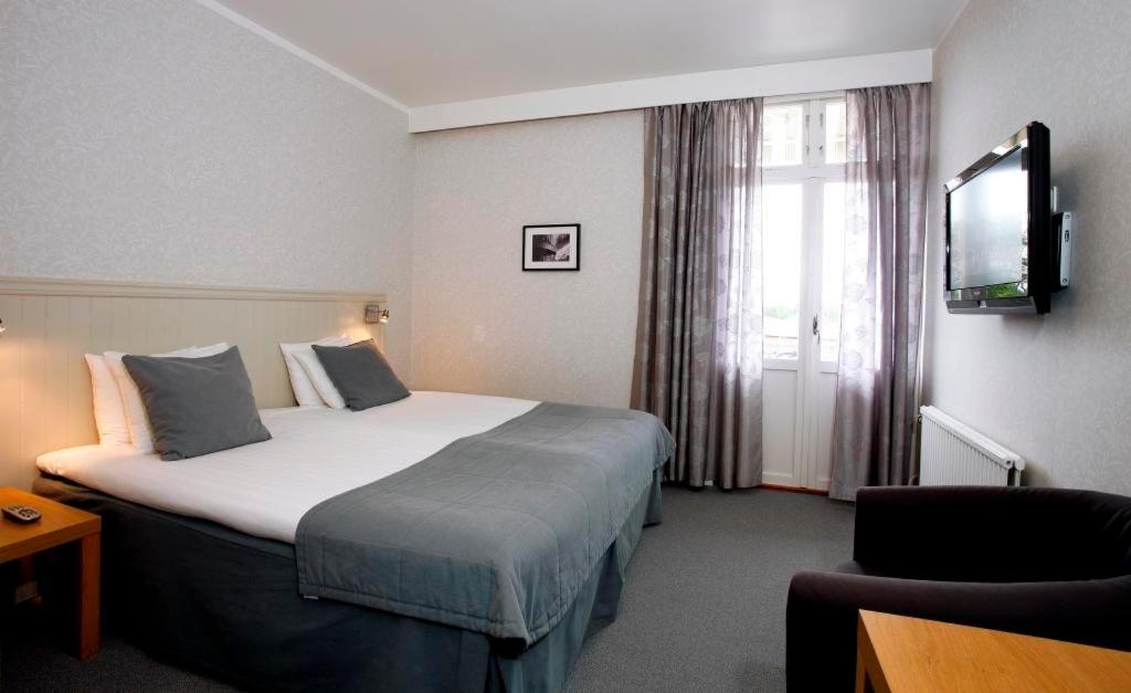 Postel nebo postele na pokoji v ubytování Adels Hotel