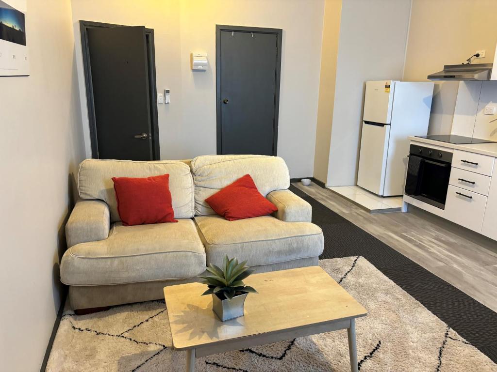 a living room with a couch and a table at Broken Hill Tourist Lodge in Broken Hill