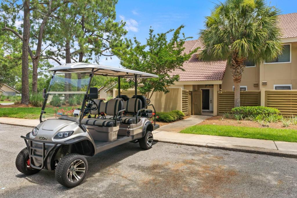 a golf cart parked in front of a house at Beachwalk Villa 5117 in Destin