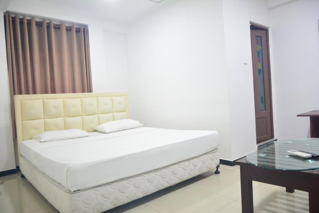 Postel nebo postele na pokoji v ubytování Saasha City Hotel