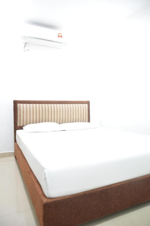 Postel nebo postele na pokoji v ubytování Saasha City Hotel