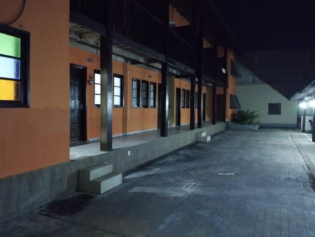 an empty hallway of a building at night at Hotel Pousada Suites Paraiso - Número 124 in Guarapari