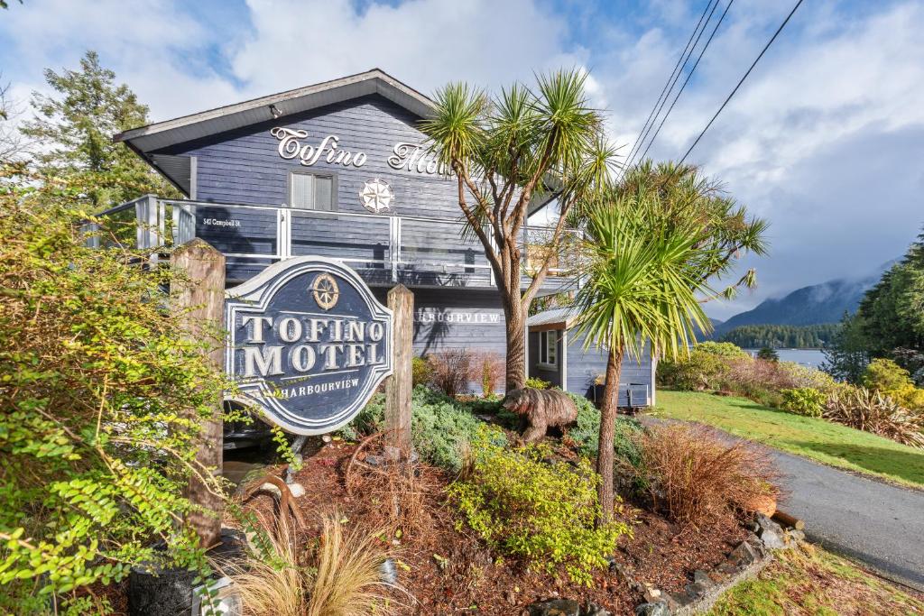 a house with a sign in front of it at Tofino Motel Harborview in Tofino