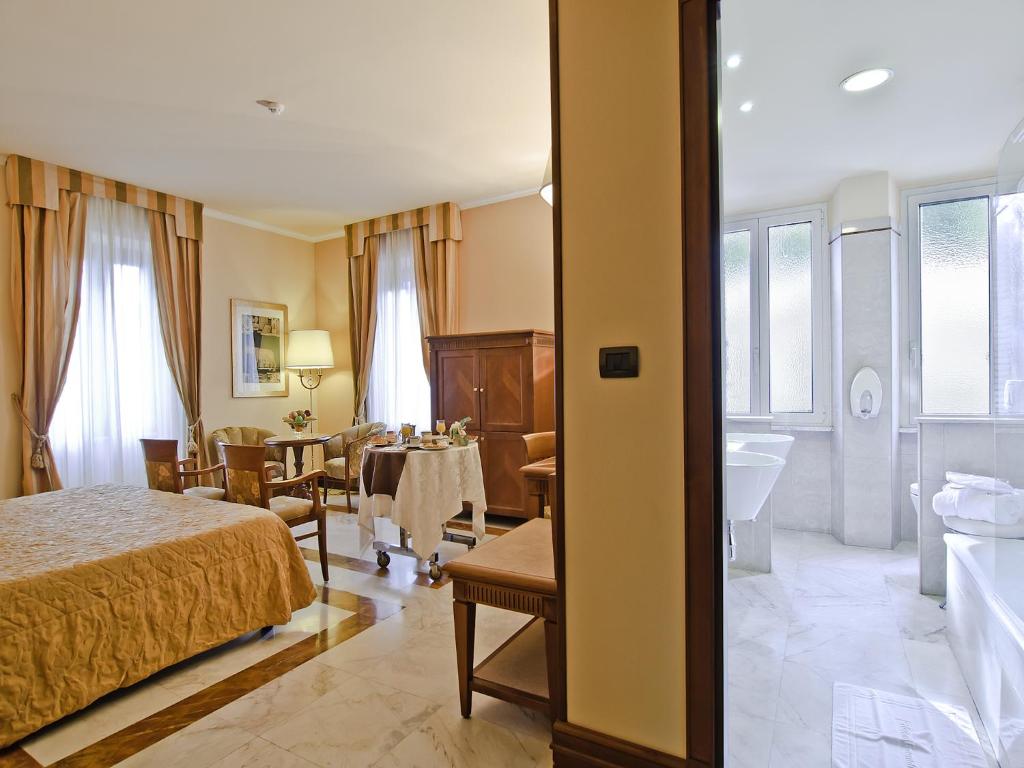 Postel nebo postele na pokoji v ubytování Tmark Hotel Vaticano