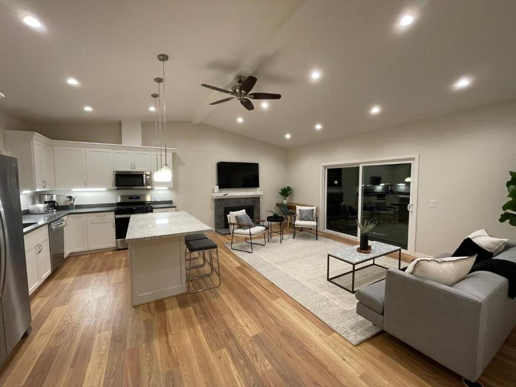 a kitchen and living room with a couch and a table at Bright Napa Home in Napa