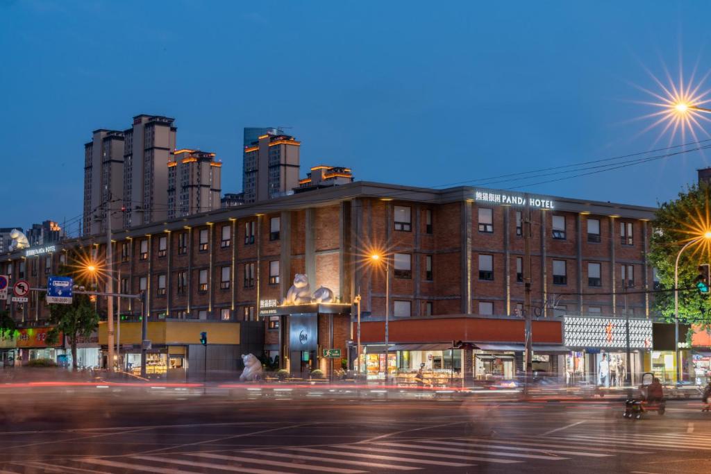 a building on a city street at night at Panda Hotel in Chengdu