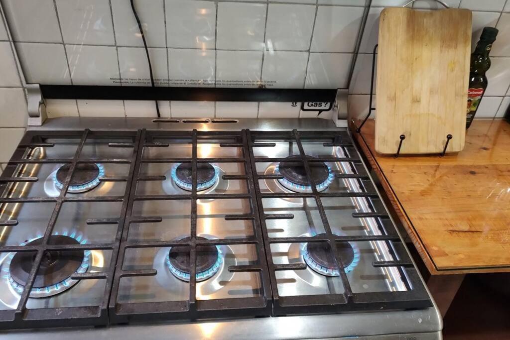 a stove top with four burners in a kitchen at Departamento en el centro Histórico CDMX. in Mexico City