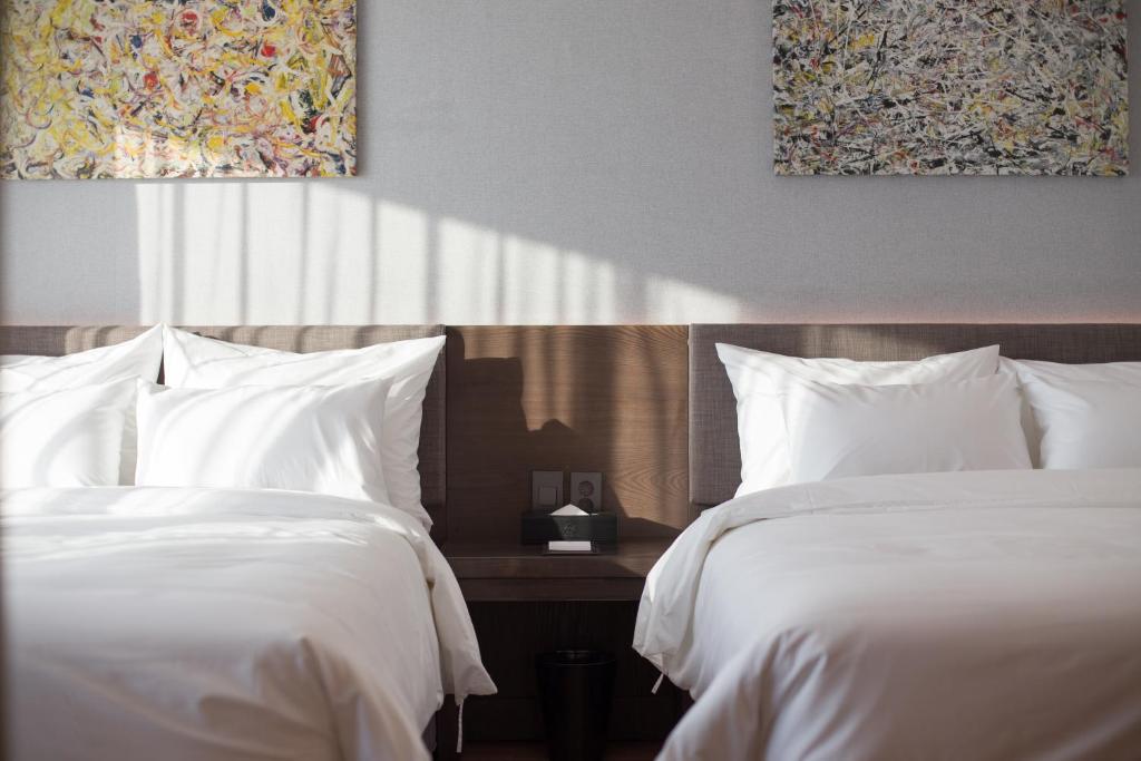 Postel nebo postele na pokoji v ubytování Dignity Hotel