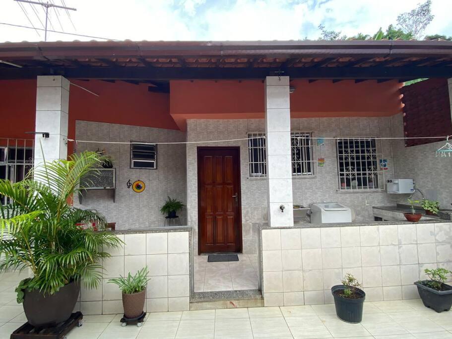 a small house with plants in front of it at Casa charmosa com varanda.ideal para trabalho. in Niterói