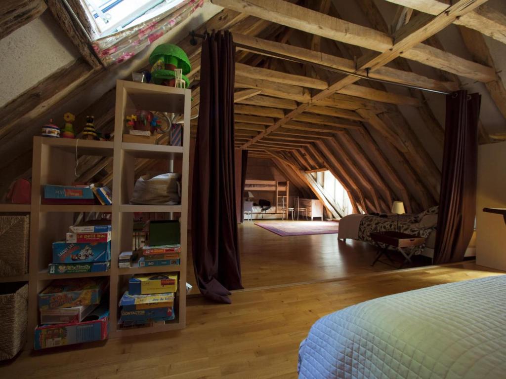 a attic room with a bed and a book shelf at Gîte Loches, 2 pièces, 6 personnes - FR-1-381-268 in Loches