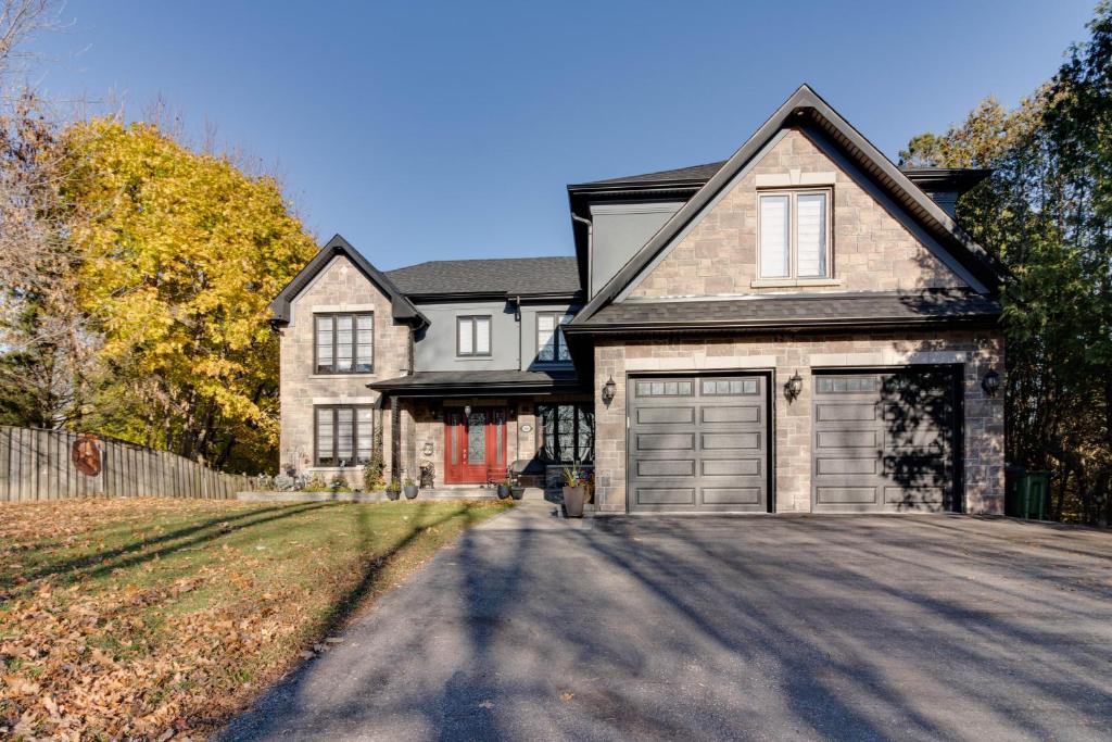 a large house with a garage on a street at Luxury house In Scarborough in Toronto