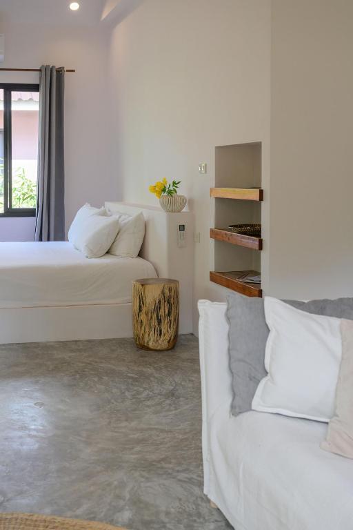 Postel nebo postele na pokoji v ubytování Boonya Swiss Home