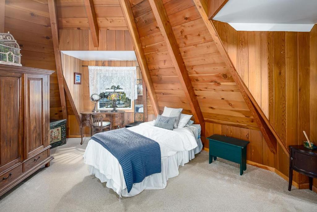 a bedroom with a bed in a room with wooden walls at The Gingerbread Cottage in Kings Beach