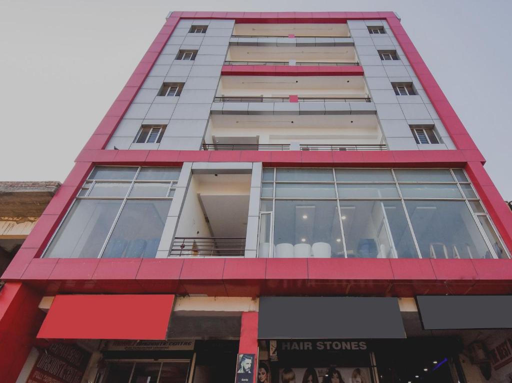 a tall building with a red trim at HC Sohana inn in Sohāna