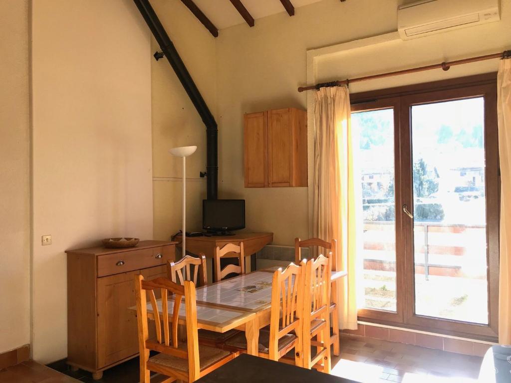 a dining room with a table and chairs and a window at Appartement Corrençon-en-Vercors, 3 pièces, 8 personnes - FR-1-515-116 in Corrençon-en-Vercors