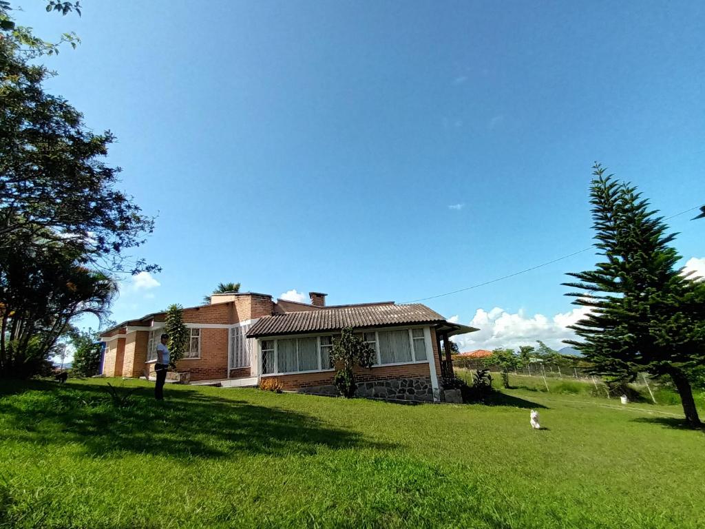 a house with a cat walking in front of it at SHEVABRAJOT in Pasto