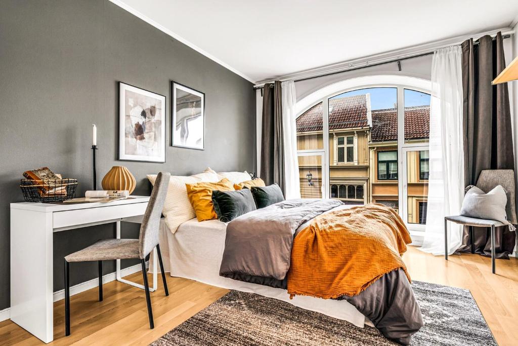 a bedroom with a bed and a desk and a window at 3 Bedroom with a perfect location in Trondheim in Trondheim