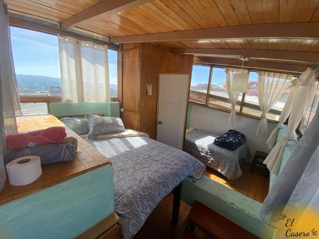 a small room with two beds and a window at Minidepa hermosa vista - H. El Casero in Cajamarca