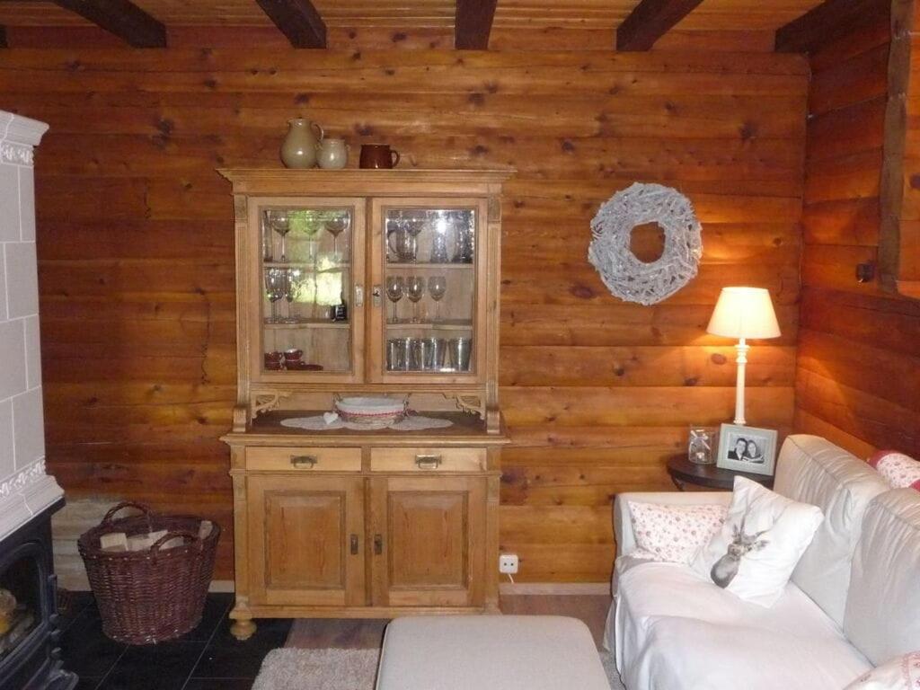 a living room with a cabinet and a couch at Holiday home in Einberger Switzerland in Rödental