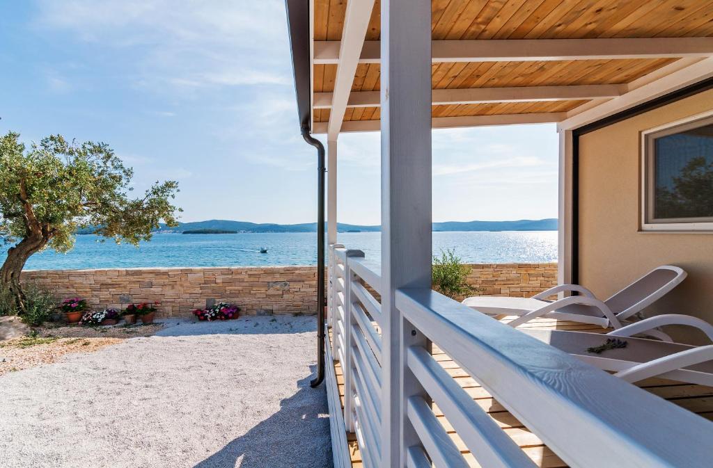 a house on the beach with a view of the ocean at San Antonio mobile homes in Biograd na Moru