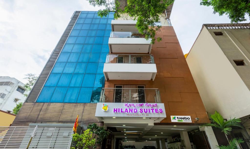 a building with a sign that reads hanoi suites at Hiland suites in Bangalore
