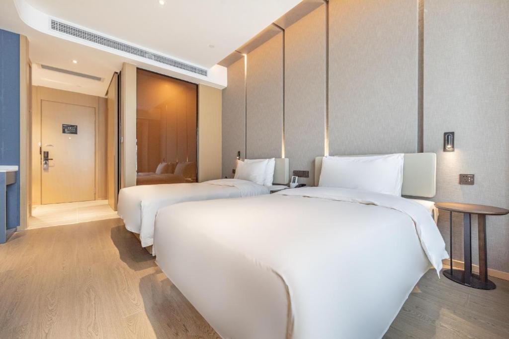 Postel nebo postele na pokoji v ubytování Atour Hotel Qingyuan Shunying Guangbai