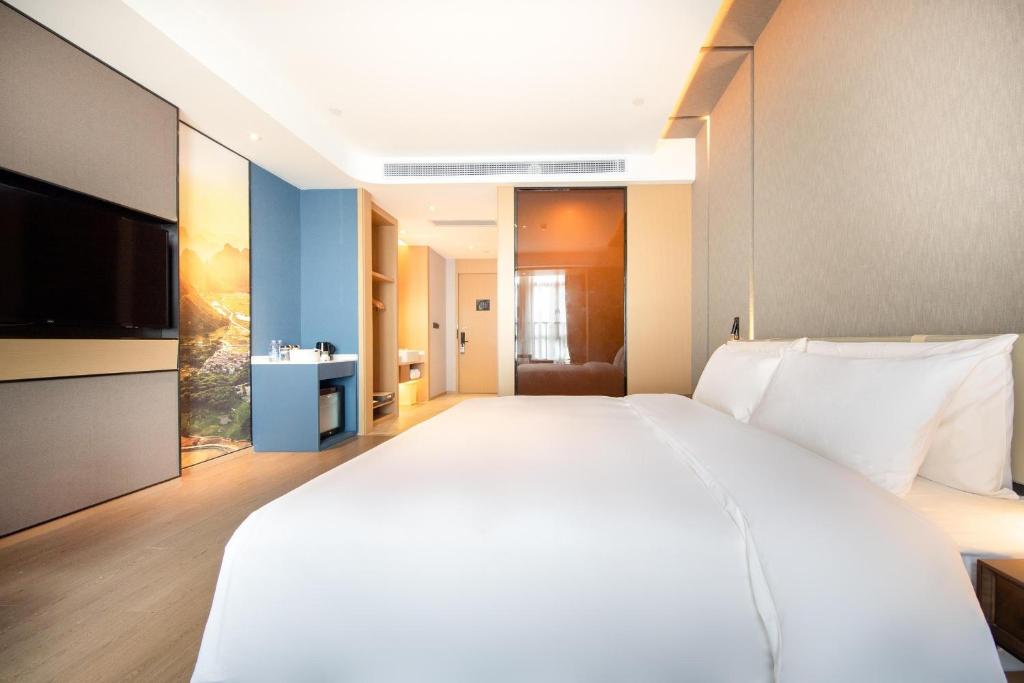 Postel nebo postele na pokoji v ubytování Atour Hotel Qingyuan Shunying Guangbai