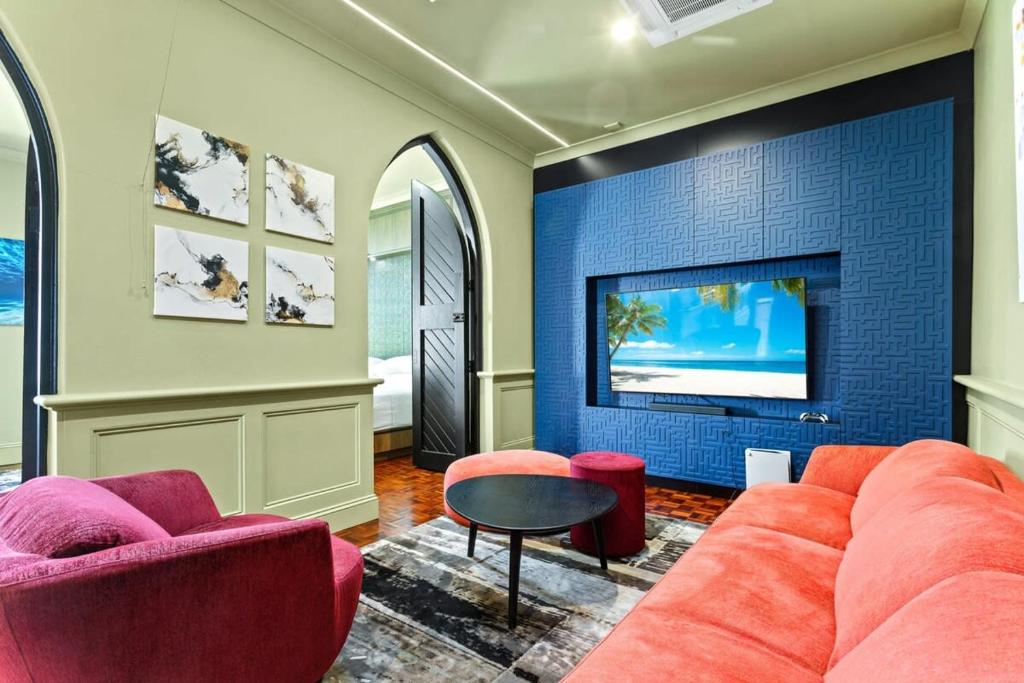 a living room with a couch and a tv at Luxury Space in Victorian Mansion with Hot Tub in Sydney