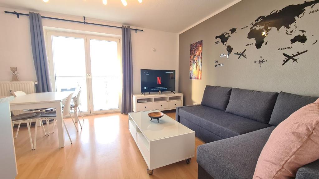 a living room with a couch and a table at Cozy 2-Room Flat, for Vacation & Fair (Messe Düsseldorf) in Ratingen