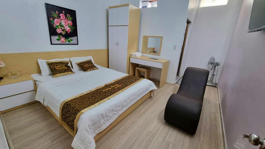 a bedroom with a bed and a chair in it at Hương Giang Hotel & Coffee in Thái Bình
