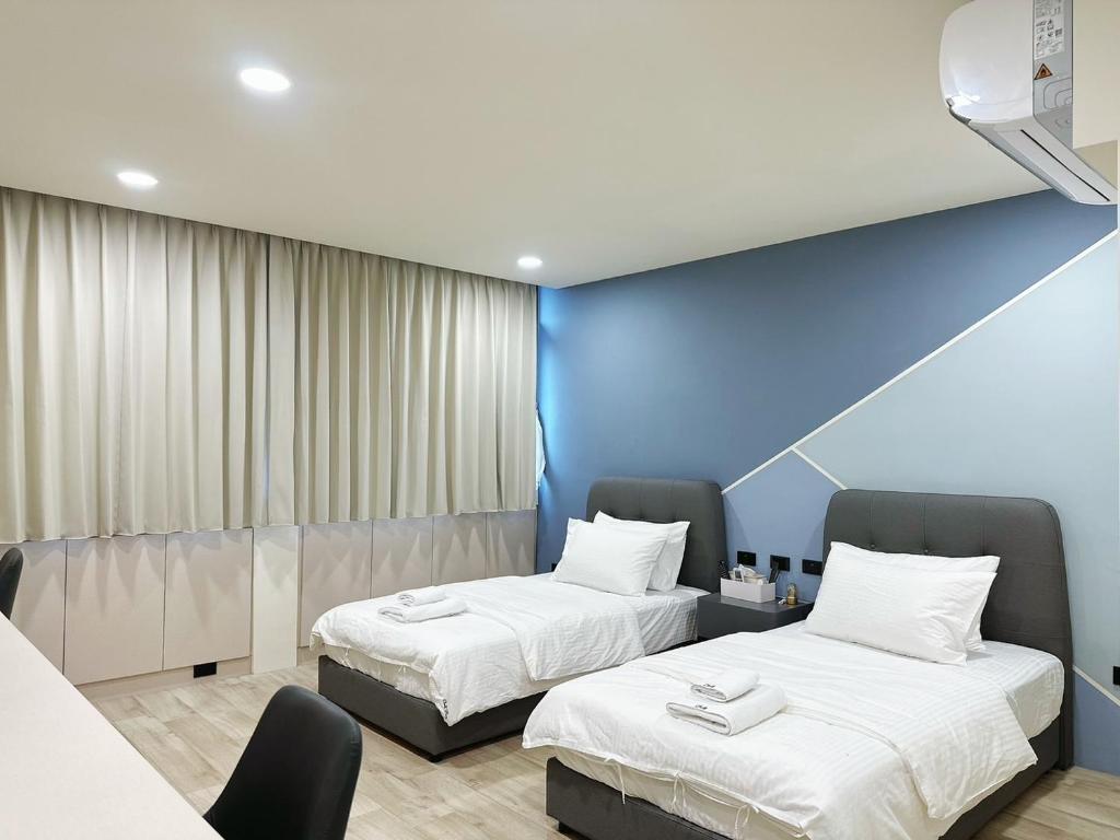竹東鎮的住宿－Chill Place 二館，蓝色墙壁客房的两张床
