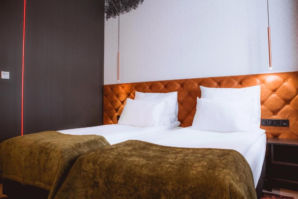 Postel nebo postele na pokoji v ubytování Hotel M23