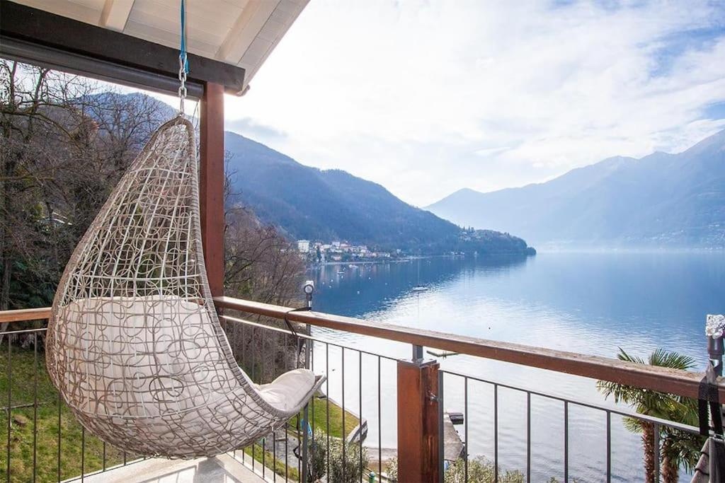 a hammock hanging on a balcony overlooking a lake at Wonderful Lake View Retreat in Gambarogno