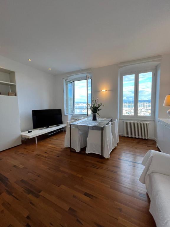 a living room with a table and some windows at About Italy Holiday Rooms and Apartments in Portovenere