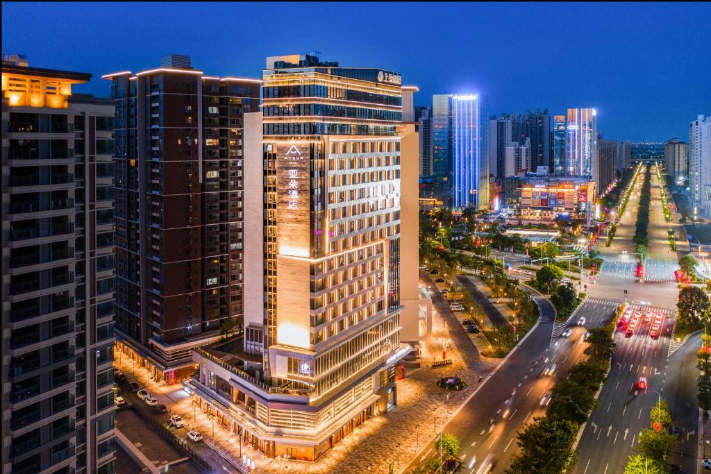 a city skyline with tall buildings and a christmas tree at Atour Hotel Zhongshan North Station V-PARK Plaza in Zhongshan