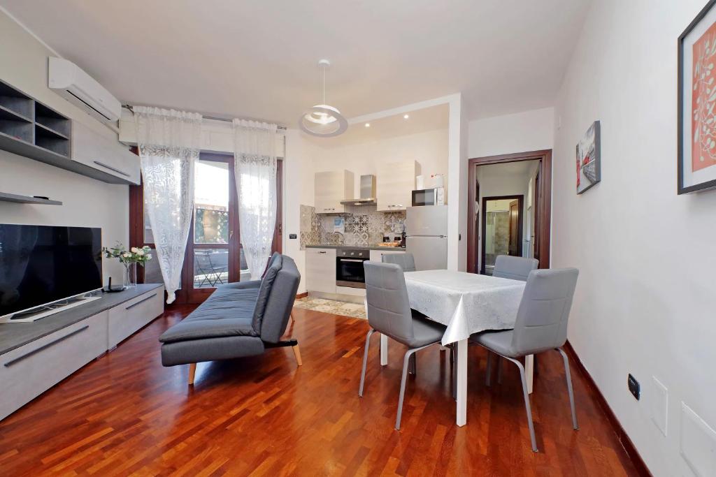 a living room with a dining room table and chairs at Copenaghen House in Fiumicino