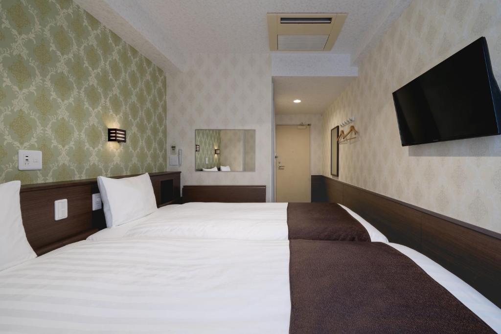 Postel nebo postele na pokoji v ubytování Hotel Centmain Nagoya