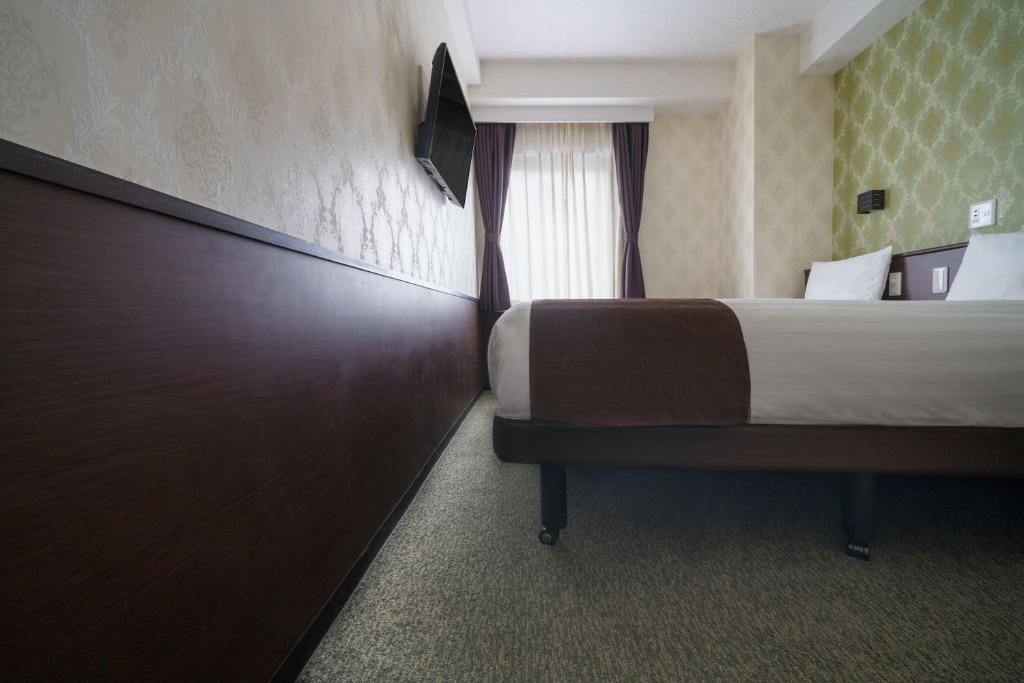 Postel nebo postele na pokoji v ubytování Hotel Centmain Nagoya