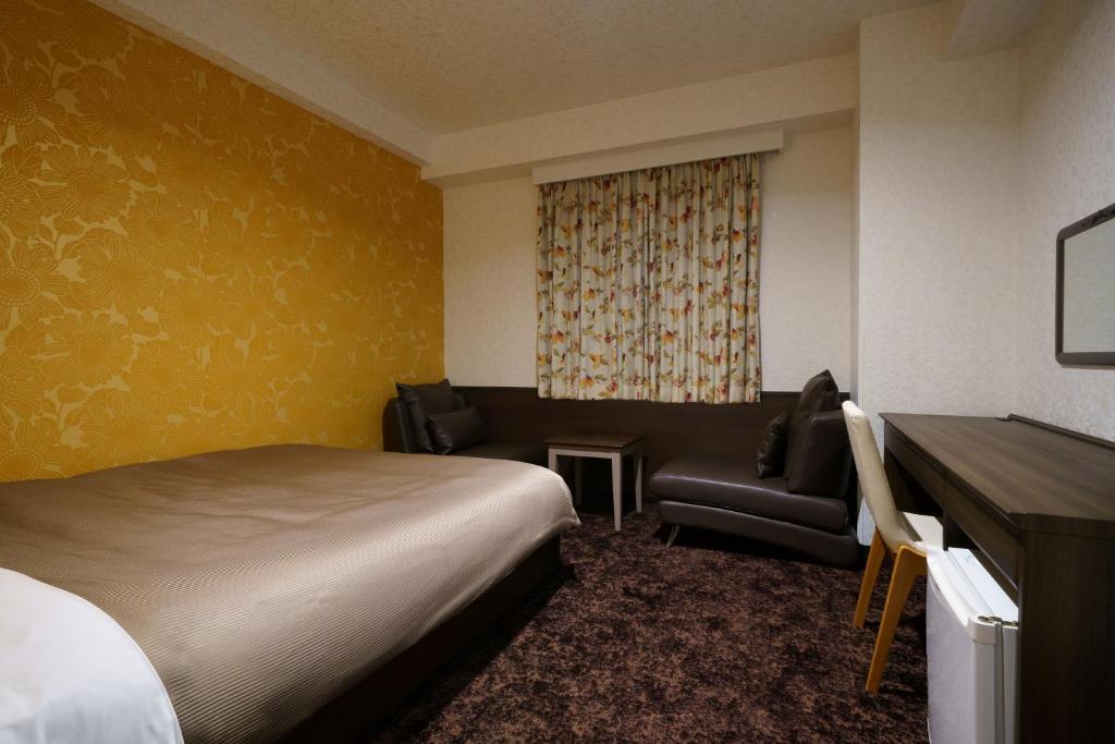 Postel nebo postele na pokoji v ubytování Hotel Centmain Nagoya