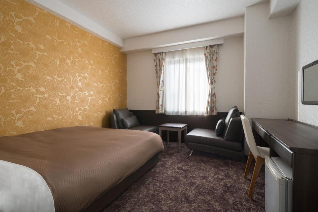 Postel nebo postele na pokoji v ubytování Hotel Centmain Nagoya