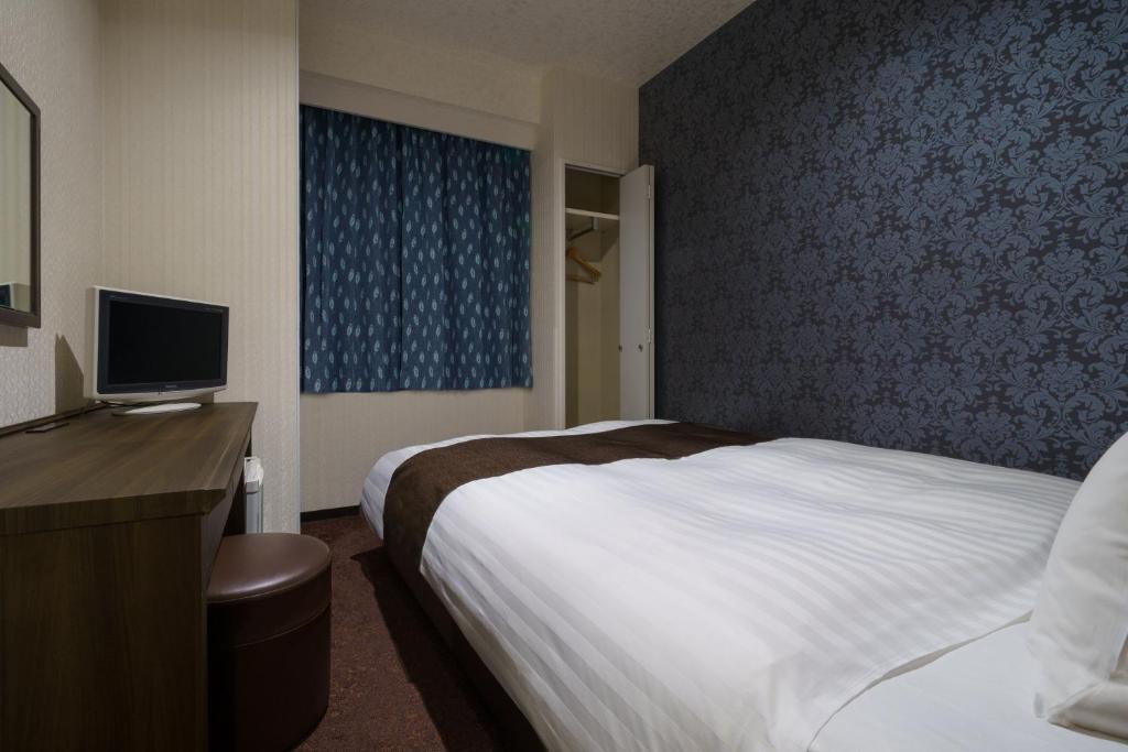 Postel nebo postele na pokoji v ubytování Hotel Centmain Nagoya