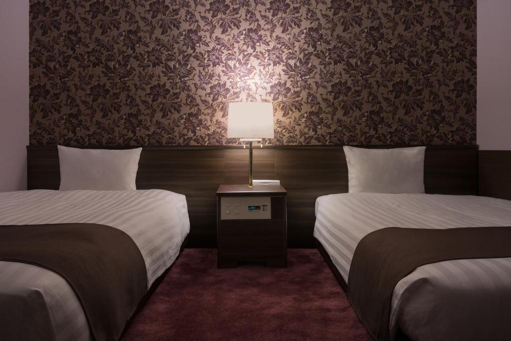 Postel nebo postele na pokoji v ubytování Hotel Centmain Nagoya