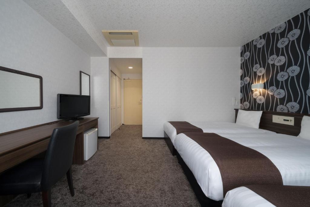 Postel nebo postele na pokoji v ubytování Hotel Centmain Nagoya