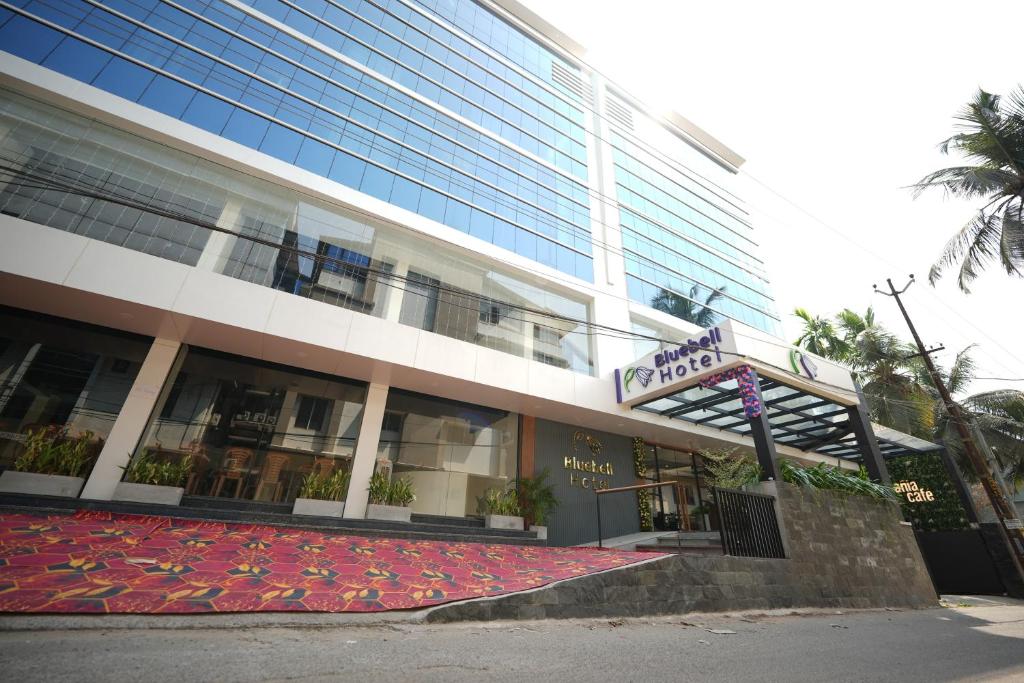 a building with a red carpet in front of it at Hotel Blue Bell in Kozhikode