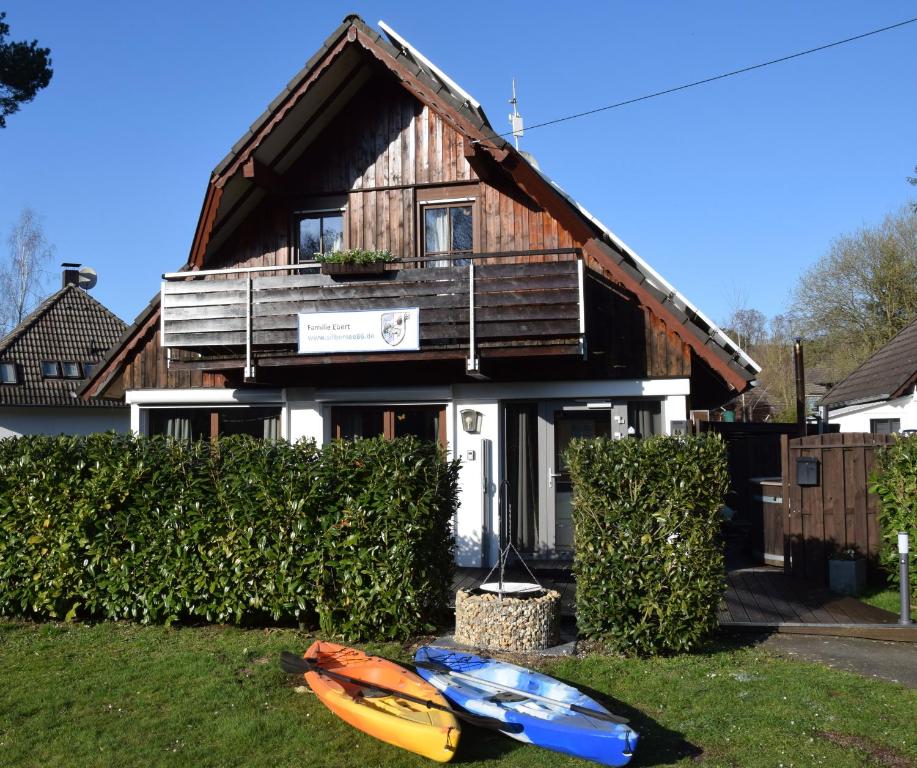 a house with two kayaks in front of it at Ferienhaus am Silbersee 86 in Frielendorf